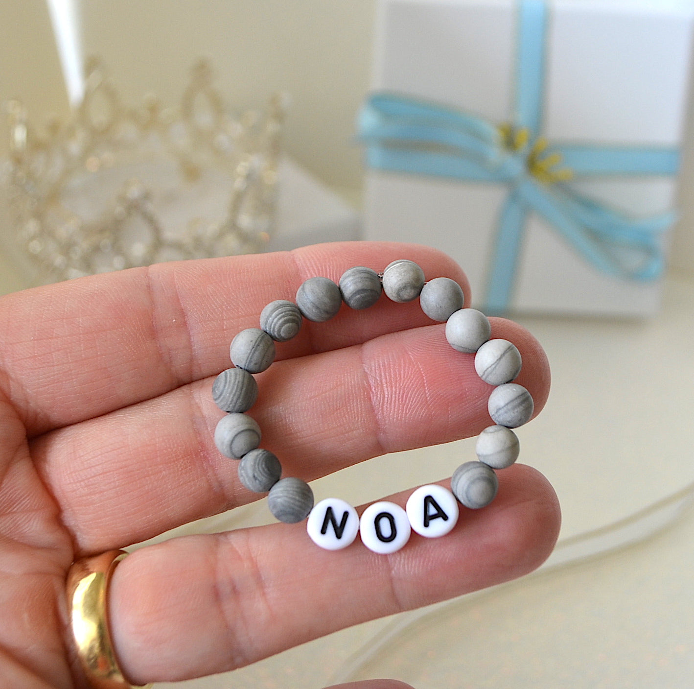 Baby boy name bracelet with grey jasper gemstones.