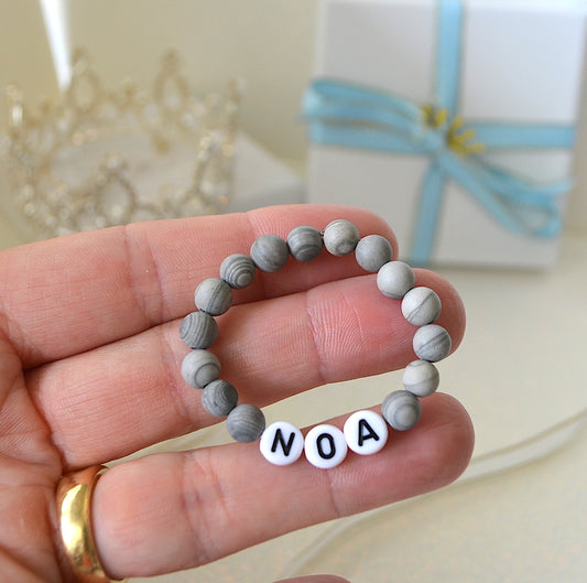 Baby boy name bracelet with grey jasper gemstones.