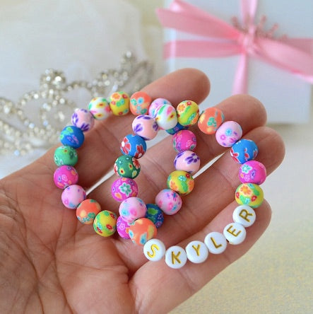Personalized colorful flower clay bracelet for girls, toddlers, and teens, handmade dainty beaded jewelry gift.